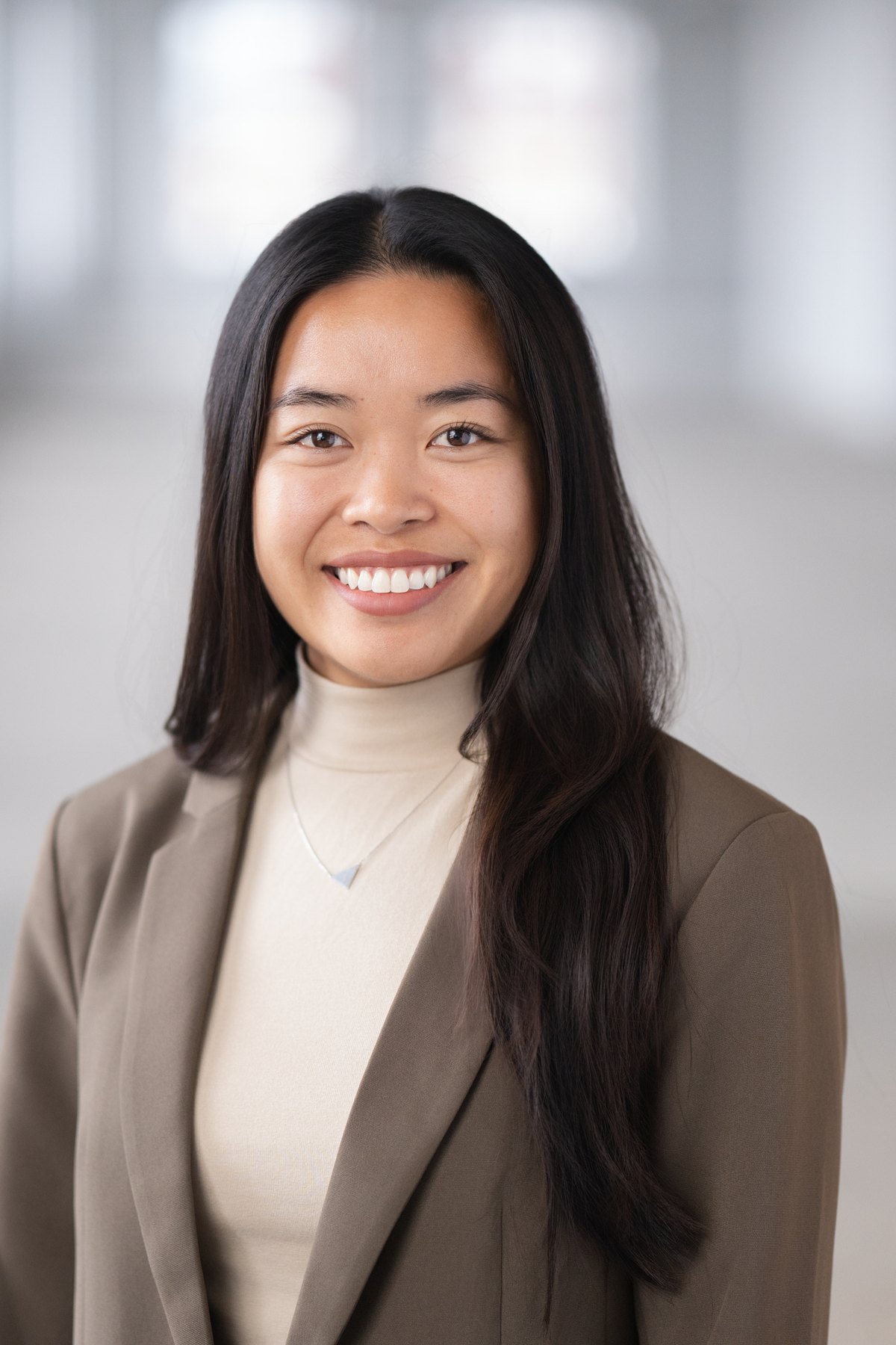 Corporate headshot with the office softened behind the subject