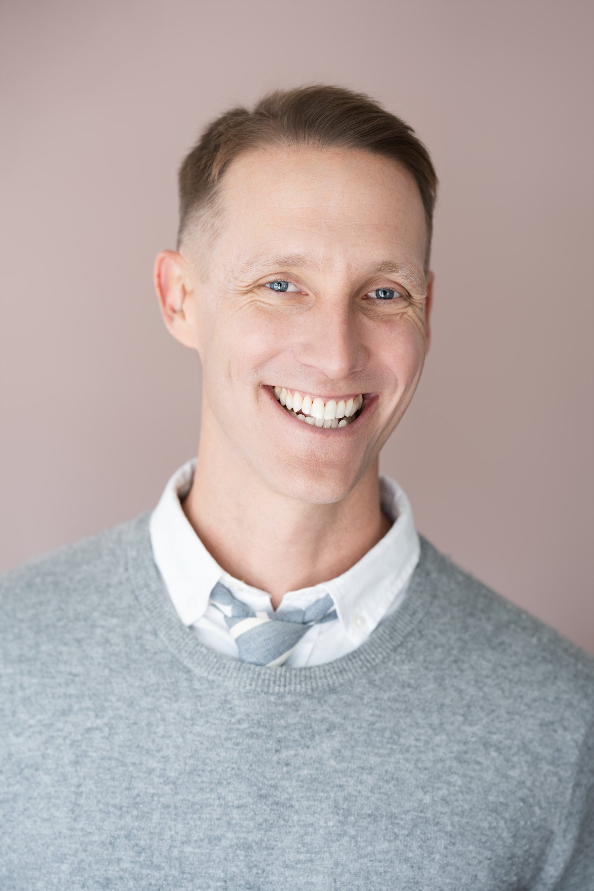 Corporate headshot on a colored seamless backdrop
