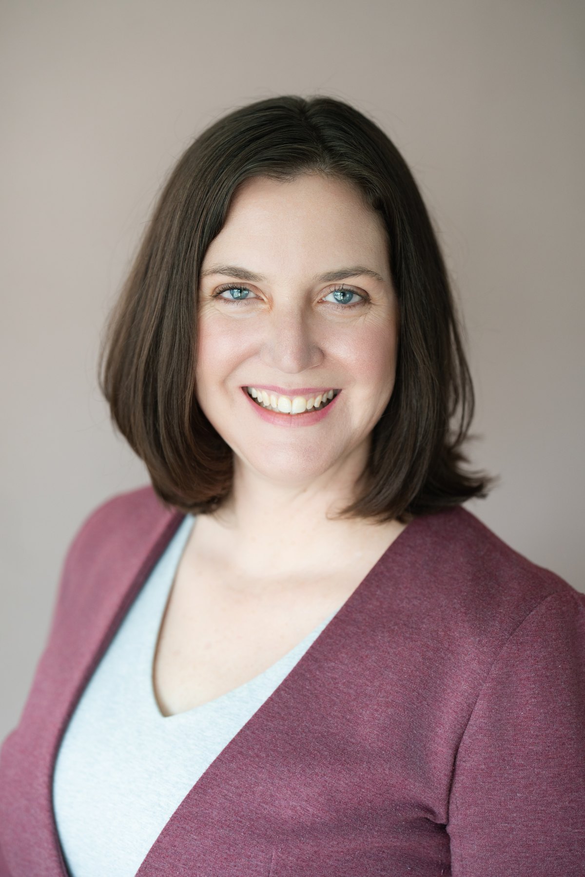 Corporate headshot on a colored seamless backdrop
