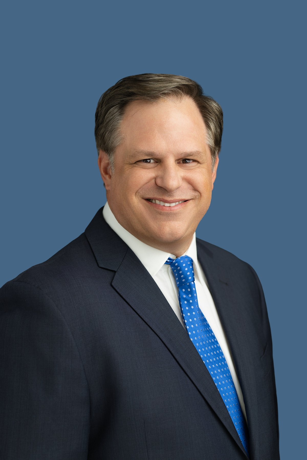 Corporate headshot on a colored seamless backdrop